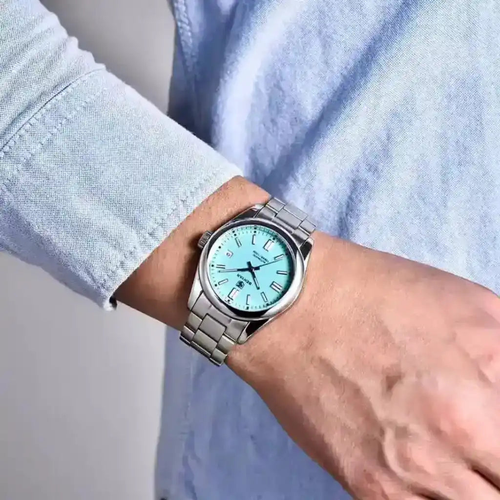 Relógio Masculino Automático Zaren Blue sendo usado no pulso evidenciando o mostrador azul elegante de 39mm e a pulseira de aço inoxidável